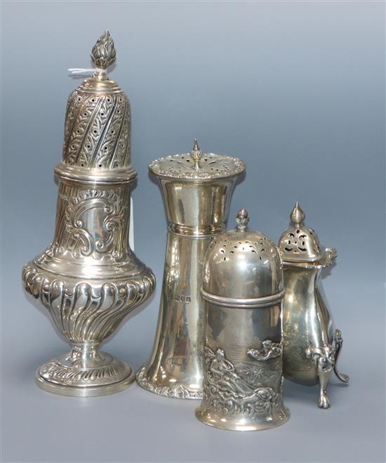 A late Victorian repousse silver sugar caster, Sheffield, 1895 and three later silver casters, largest 23cm.